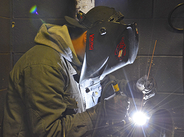 Welding student working on pipe donated by TPCO.